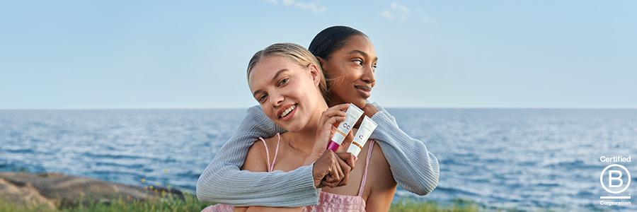 Banner för Lumene med modeller som håller upp Lumene CC Color Correcting Cream.